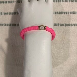 A package of multiple -colored Beaded Bracelet with Smiley Face Charm